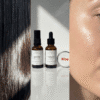 IMANY set prirodne kozmetike na beloj pozadini. Set sadrži dve tamne staklene bočice sa pipetom: "geisha" ulje za regeneraciju kose (30ml) i "bakuchi" anti-age ulje za lice (30ml), kao i jednu malu okruglu srebrnu limenku "NEŽAN" balzama za usne sa crvenim srcem na etiketi.