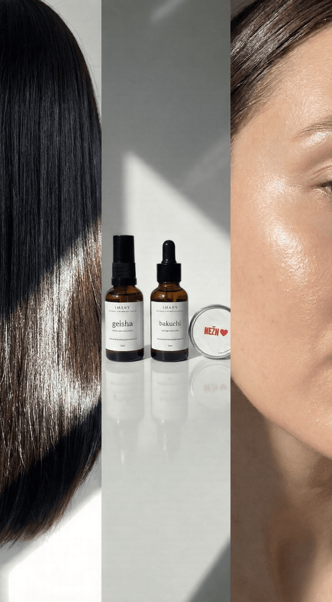 IMANY set prirodne kozmetike na beloj pozadini. Set sadrži dve tamne staklene bočice sa pipetom: "geisha" ulje za regeneraciju kose (30ml) i "bakuchi" anti-age ulje za lice (30ml), kao i jednu malu okruglu srebrnu limenku "NEŽAN" balzama za usne sa crvenim srcem na etiketi.